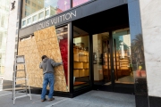 A worker installs plywood over the windows of  the Louis Vuitton store downtown  San Francisco, CA, on March 20, 2020. The luxury store had its windows covered with plywood to discourage looting.
California residents were ordered to stay home to slow the spread of the coronavirus as part of a lockdown effort.