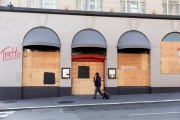 An pedestrian walks by the Italian restaurant, Tratto, that is covered with plywood  to discourage looting in San Francisco on March 31, 2020 .
Millions of San Francisco Bay Area  residents were ordered to stay home for the third week to slow the spread of the coronavirus as part of a lockdown effort.