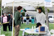 A Paramedic checks the temperature of man at a first-of-its-kind COVID-19 testing center in Hayward, CA, on March 23, 2020.  If the fever is above 100.4 degrees Fahrenheit, they will be tested for the coronavirus. The free test facility opened to  to the public this morning regardless of where the patients live or their immigration status. The entire state of California is on a shelter-in-place status ordered by the governor to slow the spread of the COVID-19 disease.