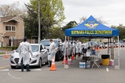Firefighters and paramedics assist people at a first-of-its-kind COVID-19 testing center in Hayward, CA, on March 23, 2020.  The free test facility opened to  to the public this morning regardless of where the patients live or their immigration status. The entire state of California is on a shelter-in-place status ordered by the governor to slow the spread of the COVID-19 disease.