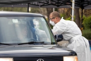 A Paramedic checks the temperature of driver at a first-of-its-kind COVID-19 testing center in Hayward, CA, on March 23, 2020.  If the fever is above 100.4 degrees Fahrenheit, they will be tested for the coronavirus. The free test facility opened to  to the public this morning regardless of where the patients live or their immigration status. The entire state of California is on a shelter-in-place status ordered by the governor to slow the spread of the COVID-19 disease.