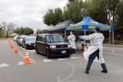 Firefighters and paramedics assist people at a first-of-its-kind COVID-19 testing center in Hayward, CA, on March 23, 2020.  The free test facility opened to  to the public this morning regardless of where the patients live or their immigration status. The entire state of California is on a shelter-in-place status ordered by the governor to slow the spread of the COVID-19 disease.