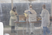 Nurse practitioners working at a drive-thru coronavirus testing site for essential workers at the Henry J. Kaiser Convention Center in Oakland, CA, on April 6, 2020. The center opened today for direct service providers such as healthcare workers, grocery and food bank workers, homeless outreach workers, and others who work directly with the public.