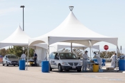 Health care workers assist people at a COVID-19 testing drive-through center in Hayward, CA, on April 15, 2020.  
Hayward firefighters with cooperation with Hayward Police and paramedics set up the center to take pressure off hospital emergency rooms. It is free and available to anyone who show symptoms such as fever.