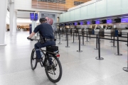 A policeman rides his bicycle through the empty terminal the San Francisco International airport on April 8, 2020.
The COVID-19 pandemic has reduced air traffic tremendously.