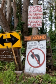 Signs at the entrance to the reclusive town of Bolinas, CA, on April 20, 2020, ask visitors to stay away because of the coronavirus pandemic.