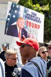 Police officers prevent protesters from entering the California State Capitol in Sacramento, CA, on May 1, 2020.