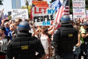 Police officers prevent protesters from entering the California State Capitol in Sacramento, CA, on May 1, 2020.