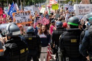 Police officers prevent protesters from entering the California State Capitol in Sacramento, CA, on May 1, 2020.