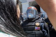 Police officers prevent protesters from entering the California State Capitol in Sacramento, CA, on May 1, 2020.