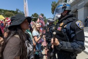 Police officers prevent protesters from entering the California State Capitol in Sacramento, CA, on May 1, 2020.