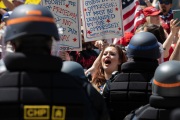 Police officers prevent protesters from entering the California State Capitol in Sacramento, CA, on May 1, 2020.