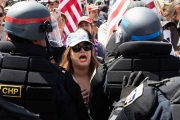 Police officers prevent protesters from entering the California State Capitol in Sacramento, CA, on May 1, 2020.