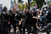 Police officers arrest a  protester n front of the California State Capitol in Sacramento, CA, on May 1, 2020.