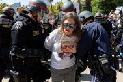 Police officers arrest a  protester n front of the California State Capitol in Sacramento, CA, on May 1, 2020.