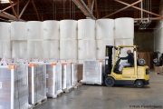 A  sighted worker drives his forklift  by 1,000-pound rolls of toilet paper and boxes of finished products inside the Sirkin Center in San Leandro, CA, on May 11, 2020.