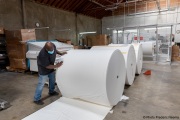 A  sighted worker prepares 1,000-pound rolls of toilet paper at the production line of toilet paper packets inside the Sirkin Center in San Leandro, CA, on May 11, 2020.