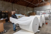 A  sighted worker prepares 1,000-pound rolls of toilet paper at the production line of toilet paper packets inside the Sirkin Center in San Leandro, CA, on May 11, 2020.