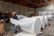 A  sighted worker prepares 1,000-pound rolls of toilet paper at the production line of toilet paper packets inside the Sirkin Center in San Leandro, CA, on May 11, 2020.