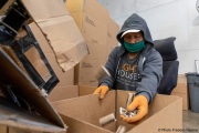 A blind worker feels the  toilet paper packets coming out of the production line at the Sirkin Center in San Leandro, CA, on May 11, 2020.