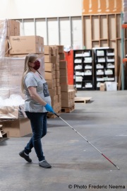 A blind worker walks through the Sirkin Center in San Leandro, CA, on May 11, 2020.