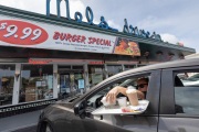 A customer getting his meal at the Mel’s Drive-In restaurant in San Francisco, CA, on May 12, 2020.Like in the 1950’s, Mel's Drive-In restaurant in San Francisco is now offering carhop service so customers stay safe while still feeling like they get the experience of eating out during the shelter-in-place order due to the coronavirus pandemic.