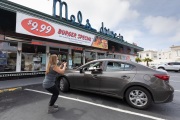 A customer getting his picture taken at the Mel’s Drive-In restaurant in San Francisco, CA, on May 12, 2020.Like in the 1950’s, Mel's Drive-In restaurant in San Francisco is now offering carhop service so customers stay safe while still feeling like they get the experience of eating out during the shelter-in-place order due to the coronavirus pandemic.