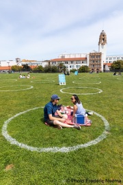 People lay on the grass inside circles drawn to encourage  social distancing at Dolores Park in San Francisco, CA, on  May 21, 2020. This effort marks the city’s latest effort to get back to some sort of normalcy following the long shelter-in-place order while trying to keep the risks of infection from the coronavirus to the minimum.