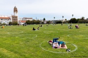 People lay on the grass inside circles drawn to encourage  social distancing at Dolores Park in San Francisco, CA, on  May 21, 2020. This effort marks the city’s latest effort to get back to some sort of normalcy following the long shelter-in-place order while trying to keep the risks of infection from the coronavirus to the minimum.