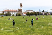 People lay on the grass inside circles drawn to encourage  social distancing at Dolores Park in San Francisco, CA, on  May 21, 2020. This effort marks the city’s latest effort to get back to some sort of normalcy following the long shelter-in-place order while trying to keep the risks of infection from the coronavirus to the minimum.