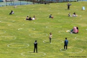 People lay on the grass inside circles drawn to encourage  social distancing at Dolores Park in San Francisco, CA, on  May 21, 2020. This effort marks the city’s latest effort to get back to some sort of normalcy following the long shelter-in-place order while trying to keep the risks of infection from the coronavirus to the minimum.