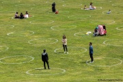 People lay on the grass inside circles drawn to encourage  social distancing at Dolores Park in San Francisco, CA, on  May 21, 2020. This effort marks the city’s latest effort to get back to some sort of normalcy following the long shelter-in-place order while trying to keep the risks of infection from the coronavirus to the minimum.