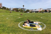 People lay on the grass inside circles drawn to encourage  social distancing at Dolores Park in San Francisco, CA, on  May 21, 2020. This effort marks the city’s latest effort to get back to some sort of normalcy following the long shelter-in-place order while trying to keep the risks of infection from the coronavirus to the minimum.