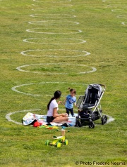 People lay on the grass inside circles drawn to encourage  social distancing at Dolores Park in San Francisco, CA, on  May 21, 2020. This effort marks the city’s latest effort to get back to some sort of normalcy following the long shelter-in-place order while trying to keep the risks of infection from the coronavirus to the minimum.