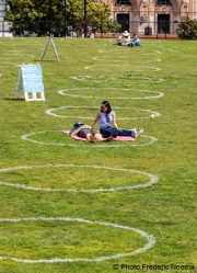 People lay on the grass inside circles drawn to encourage  social distancing at Dolores Park in San Francisco, CA, on  May 21, 2020. This effort marks the city’s latest effort to get back to some sort of normalcy following the long shelter-in-place order while trying to keep the risks of infection from the coronavirus to the minimum.