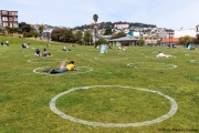 People lay on the grass inside circles drawn to encourage  social distancing at Dolores Park in San Francisco, CA, on  May 21, 2020. This effort marks the city’s latest effort to get back to some sort of normalcy following the long shelter-in-place order while trying to keep the risks of infection from the coronavirus to the minimum.