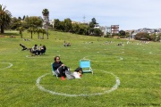 People lay on the grass inside circles drawn to encourage  social distancing at Dolores Park in San Francisco, CA, on  May 21, 2020. This effort marks the city’s latest effort to get back to some sort of normalcy following the long shelter-in-place order while trying to keep the risks of infection from the coronavirus to the minimum.