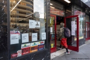 A man enters a store  in Oakland, CA, on May 30, 2020, which has its front filled with words in  support of George Floyd in Minneapolis, MN, who passed away while pleading with arresting officers that he couldn't breathe as one of the officers was shown on video kneeling on his neck.