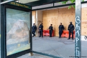 Police officers stand guard in front of Chase bank  in Oakland, CA, on May 30, 2020, that had its storefront boarded up following violent  protests the night before.
